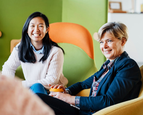 Two women sitting in a meeting