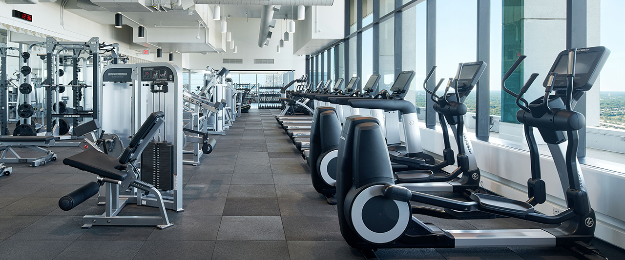 Specious workout center with exercise equipment.