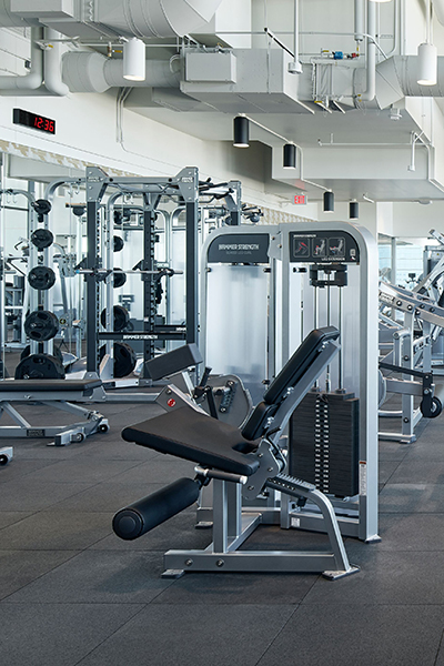 Specious workout center with exercise equipment.