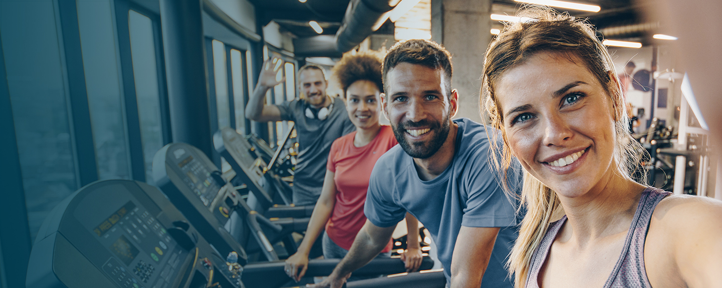 Several adults on treadmill machines