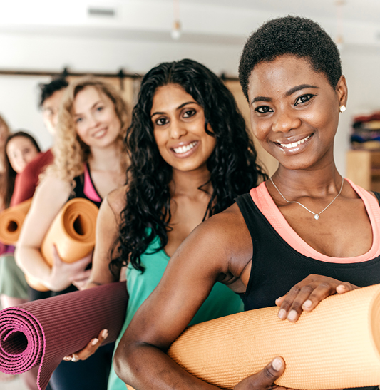 group of women with yoga mats