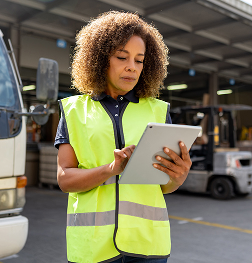 Equipment rental worker looking at the tablet.