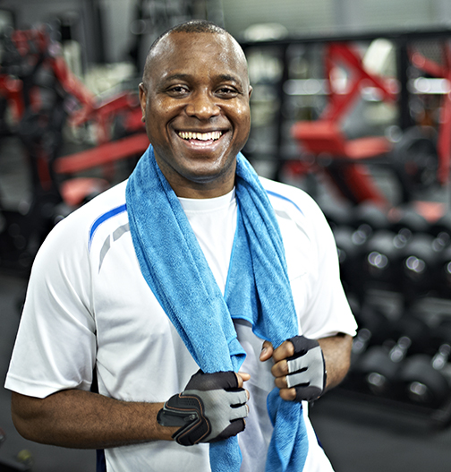 Happy man in the fitness center.