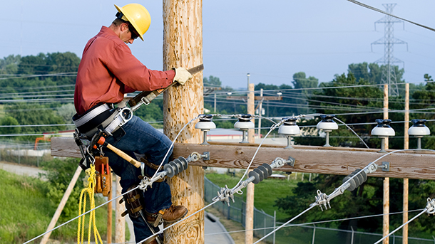 utility worker on pole